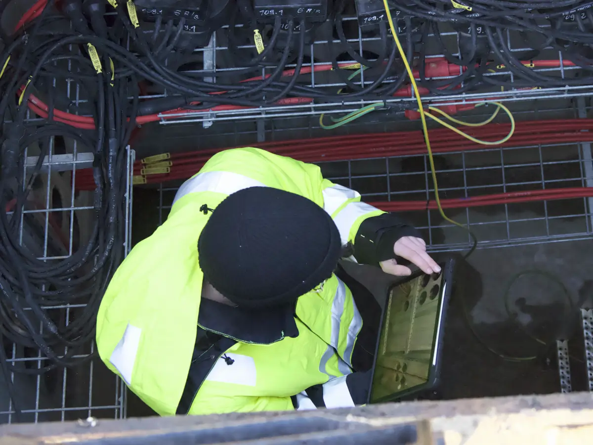 Technician with tablet on the tarmac in front of an aircraft